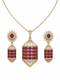 Gold jewelry set featuring a pendant necklace and matching drop earrings with deep pinkish-red round gemstones and clear stones, displayed on a white background.